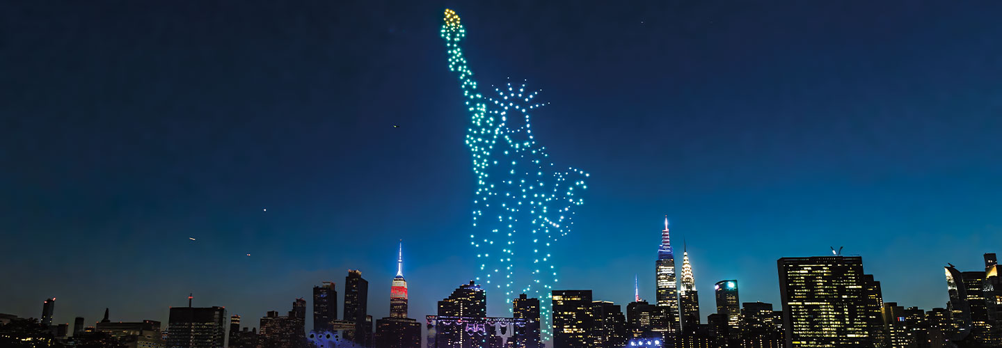 Image of Statue of Liberty in lights over a city